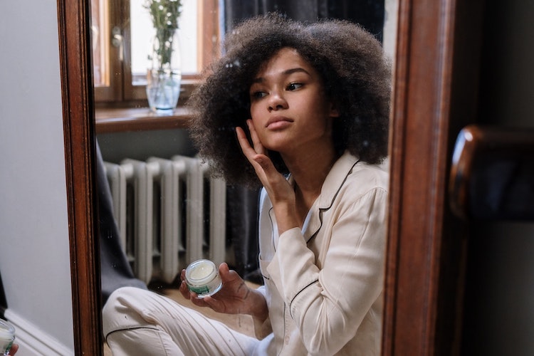person applying face cream