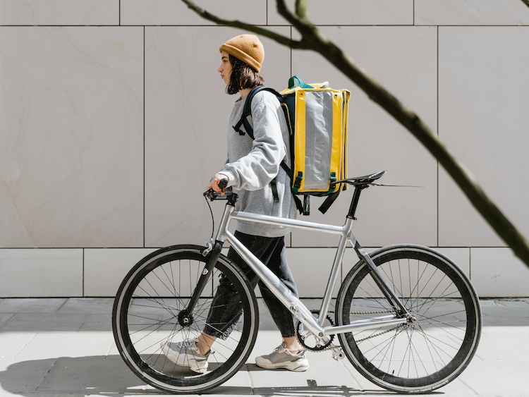 woman with bicycle delivering food