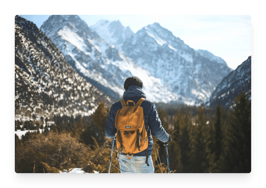 man wearing backpack in the mountains
