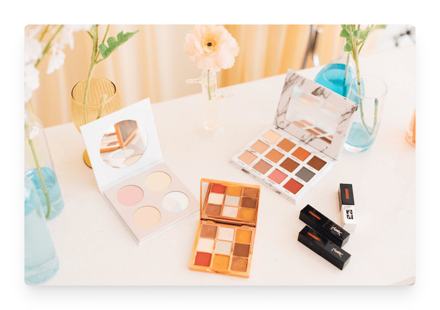 eye shadow palettes and lipstick on table